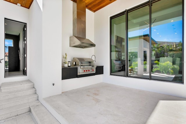 kitchen featuring wall chimney exhaust hood