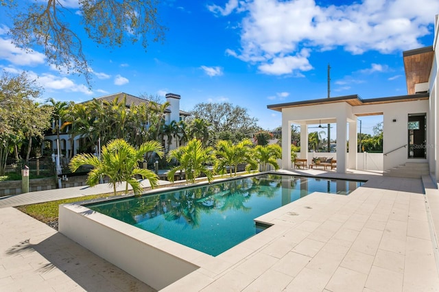 pool featuring a patio area and fence
