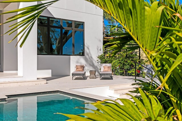 view of swimming pool featuring a deck