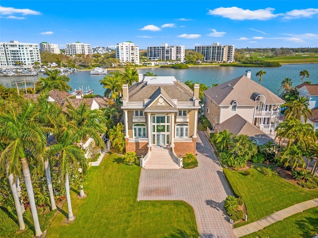 birds eye view of property with a water view and a city view