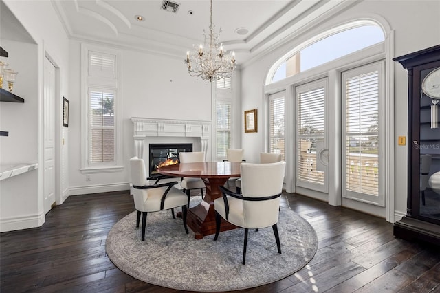 dining space featuring a raised ceiling, visible vents, dark wood-style flooring, and a healthy amount of sunlight