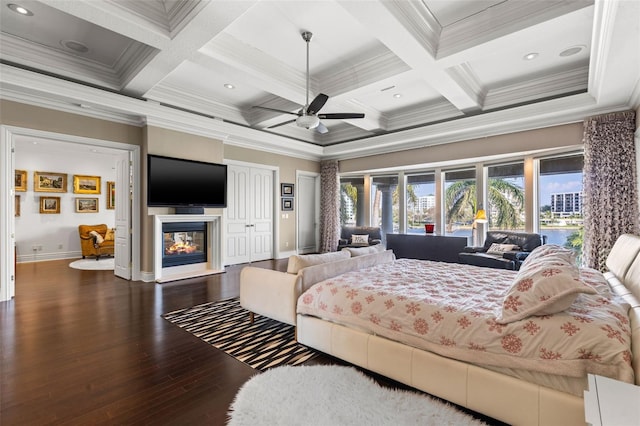 bedroom featuring beam ceiling, crown molding, wood finished floors, coffered ceiling, and a multi sided fireplace