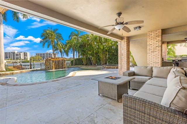 view of patio / terrace featuring a ceiling fan, an outdoor pool, an outdoor living space with a fire pit, and fence