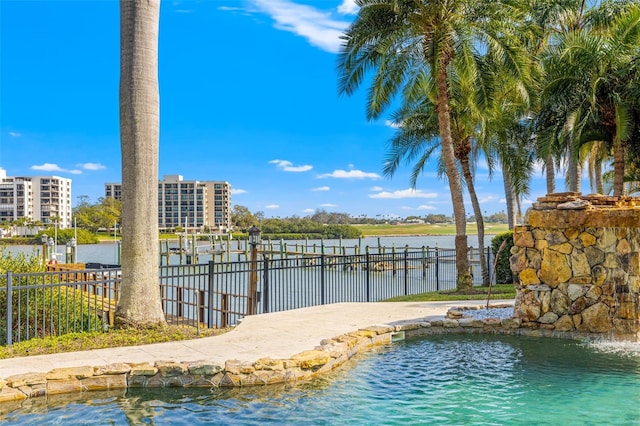 view of dock featuring a water view and fence