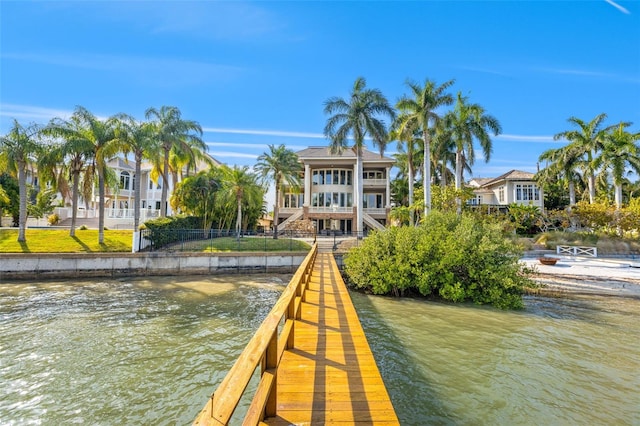 view of dock featuring a water view and fence