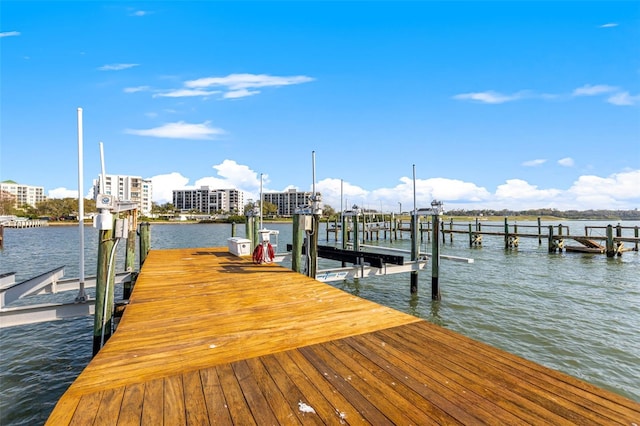 dock area with a water view and boat lift