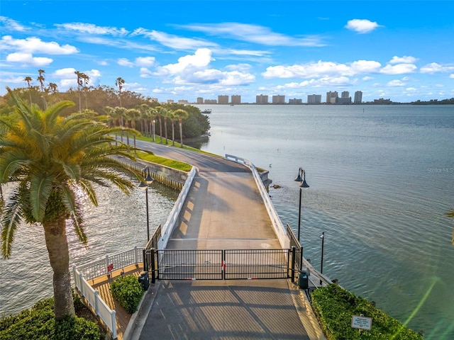 view of dock with a water view and a view of city