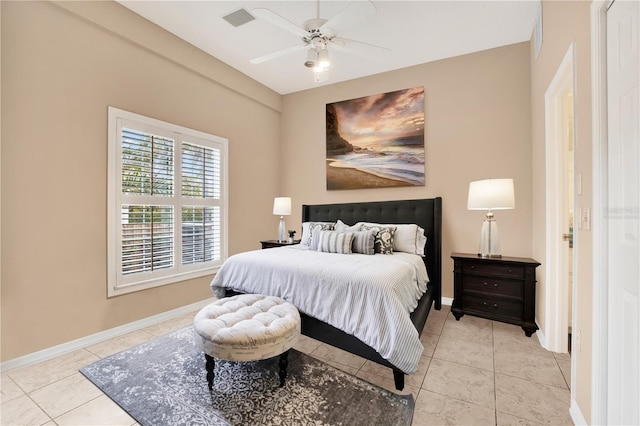 bedroom featuring light tile patterned floors, baseboards, and a ceiling fan