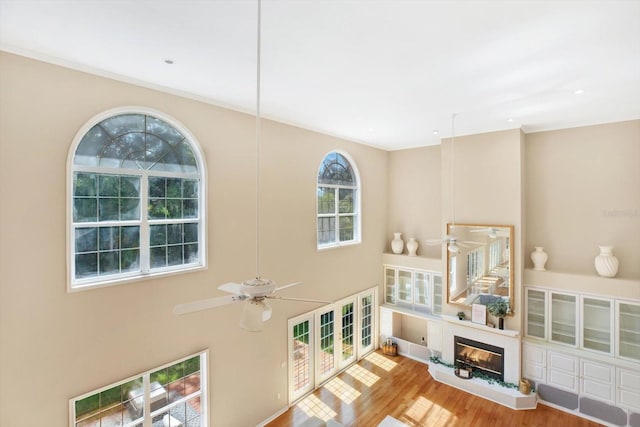 interior space with wood finished floors and a glass covered fireplace