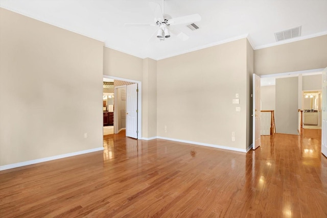 empty room featuring visible vents, ceiling fan, light wood-style flooring, and baseboards