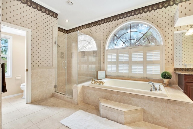 full bath featuring a stall shower, wallpapered walls, toilet, tile patterned floors, and a garden tub