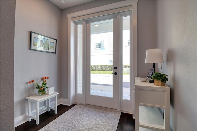 doorway to outside featuring dark wood-style floors and baseboards