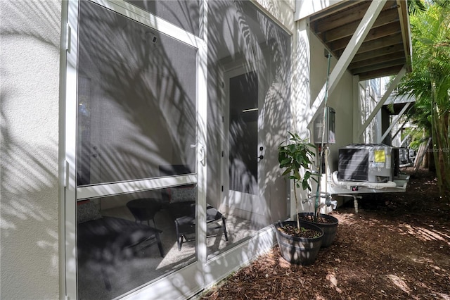 exterior space featuring cooling unit and stucco siding