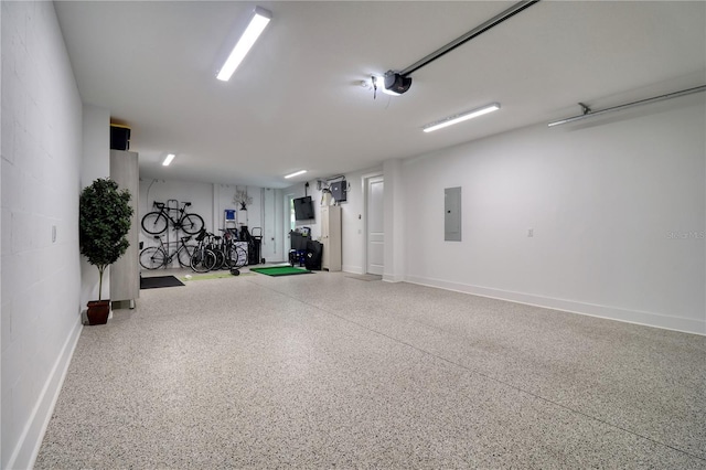 garage featuring baseboards, electric panel, and a garage door opener