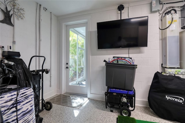 interior space featuring concrete block wall and speckled floor