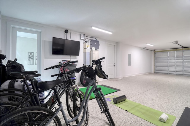 exercise room featuring a garage and electric panel