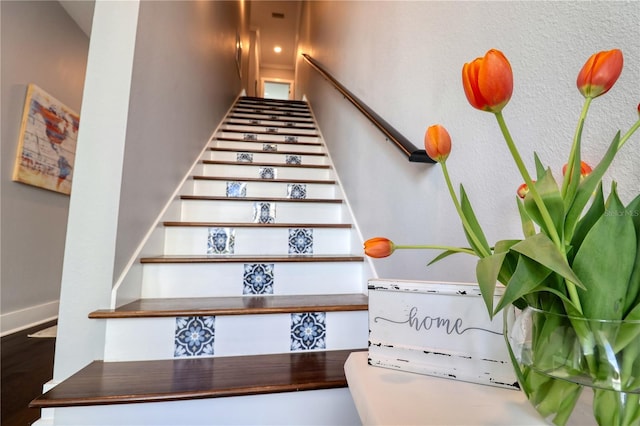 staircase featuring baseboards