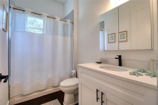 bathroom with toilet, shower / bath combo with shower curtain, wood finished floors, and vanity