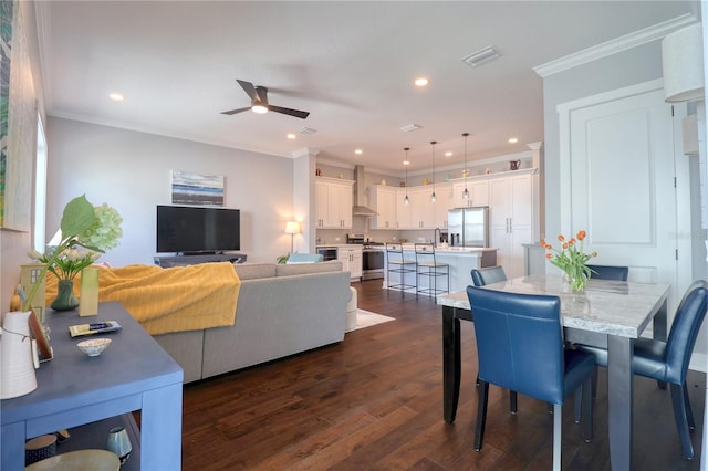 dining space with visible vents, a ceiling fan, dark wood-style floors, ornamental molding, and recessed lighting