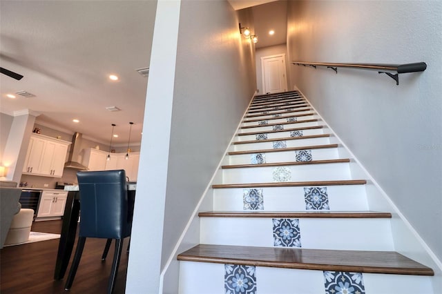 stairway featuring wine cooler, visible vents, recessed lighting, and wood finished floors