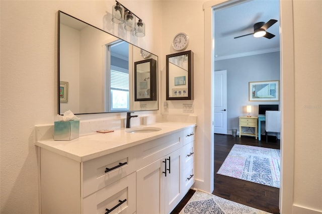 bathroom featuring ceiling fan, wood finished floors, vanity, and crown molding