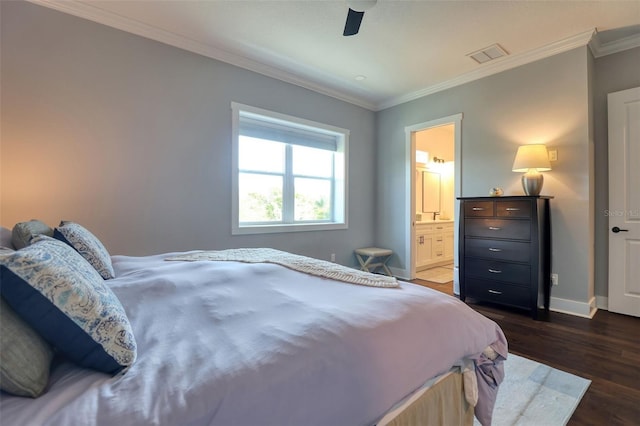 bedroom with ensuite bathroom, visible vents, baseboards, dark wood-style floors, and crown molding