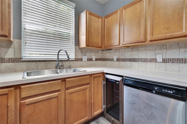 kitchen featuring beverage cooler, decorative backsplash, light countertops, stainless steel dishwasher, and a sink