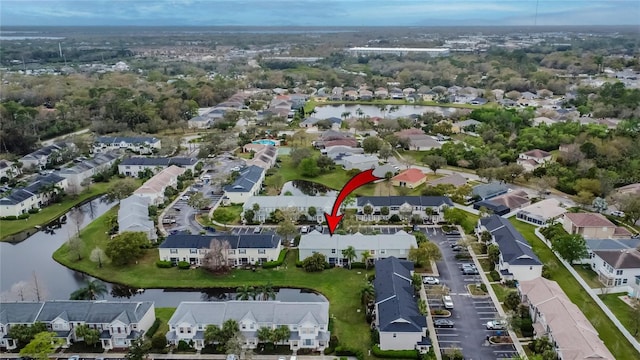 drone / aerial view featuring a residential view and a water view