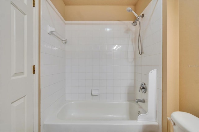 bathroom featuring washtub / shower combination and toilet