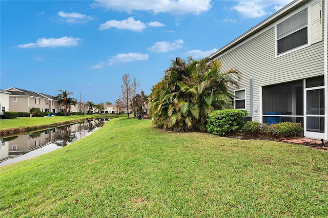 view of yard with a water view and a residential view