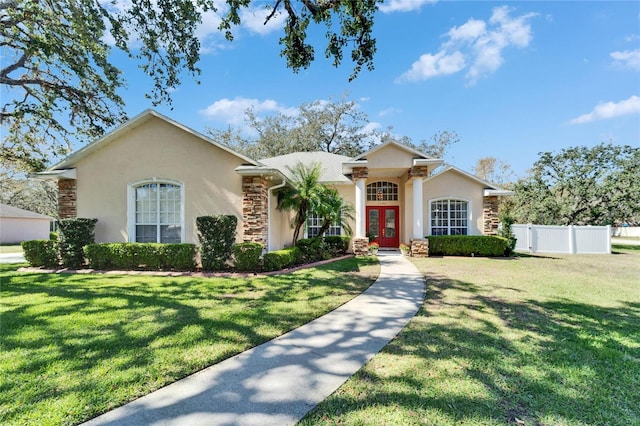 single story home with stone siding, french doors, fence, and stucco siding