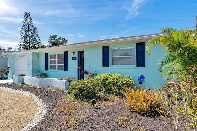 view of front of house with a garage and stucco siding