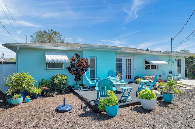 rear view of property with french doors and a patio area