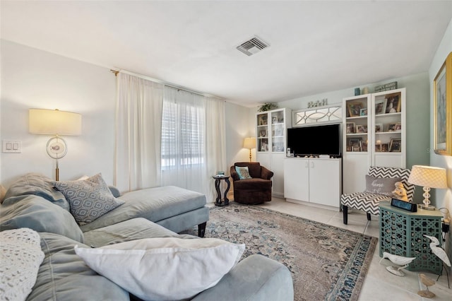 tiled living room featuring visible vents