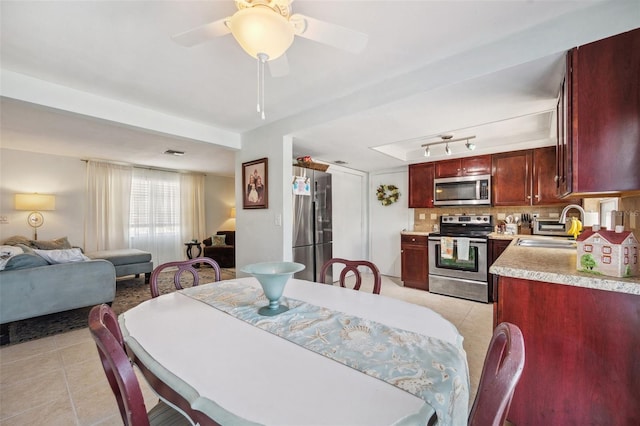 dining space with light tile patterned flooring and ceiling fan