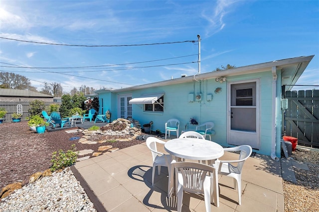 view of patio / terrace featuring fence and outdoor dining area