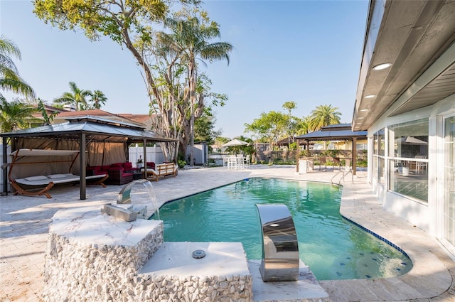 view of swimming pool featuring a gazebo, a fenced in pool, a patio, and fence