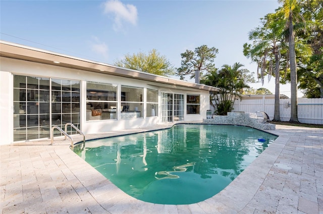 view of swimming pool featuring a patio area, a fenced in pool, and fence