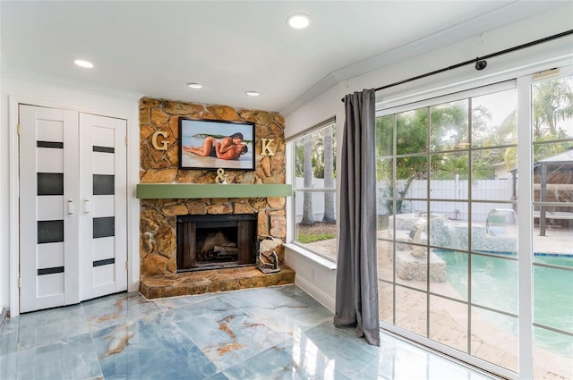 unfurnished living room featuring recessed lighting, marble finish floor, a fireplace, and ornamental molding