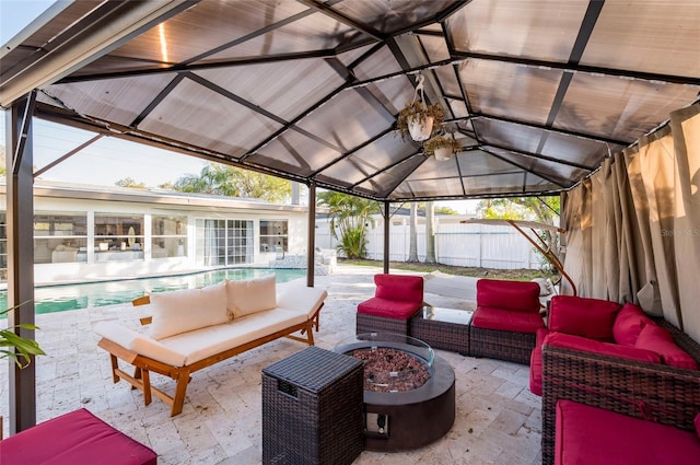 view of patio / terrace featuring a fenced in pool, an outdoor living space with a fire pit, and a fenced backyard