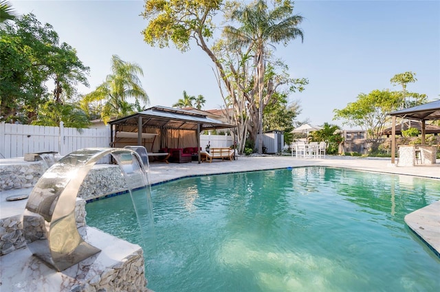 view of swimming pool with a gazebo, fence, a fenced in pool, and a patio area