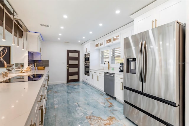 kitchen with visible vents, a sink, recessed lighting, appliances with stainless steel finishes, and white cabinets