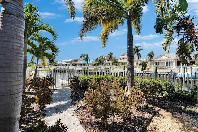 5616 Seagrass Pl, Apollo Beach, FL 33572 - view of yard with a water view, a residential view, a gate, and fence