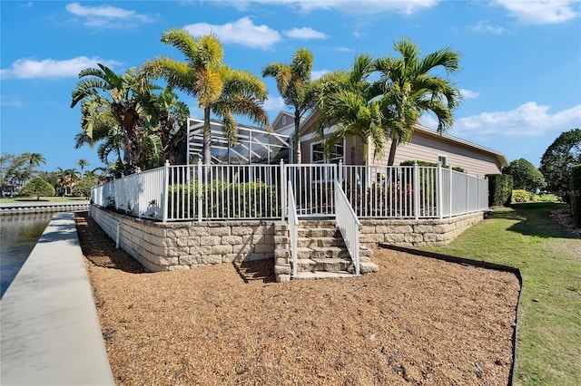 5616 Seagrass Pl, Apollo Beach, FL 33572 - exterior space featuring glass enclosure and a lawn