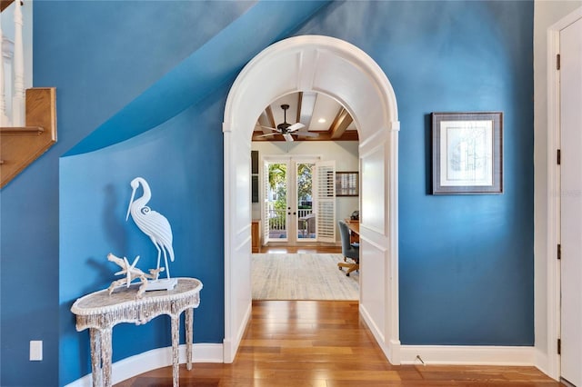 5616 Seagrass Pl, Apollo Beach, FL 33572 - corridor featuring baseboards, arched walkways, hardwood / wood-style flooring, french doors, and beam ceiling
