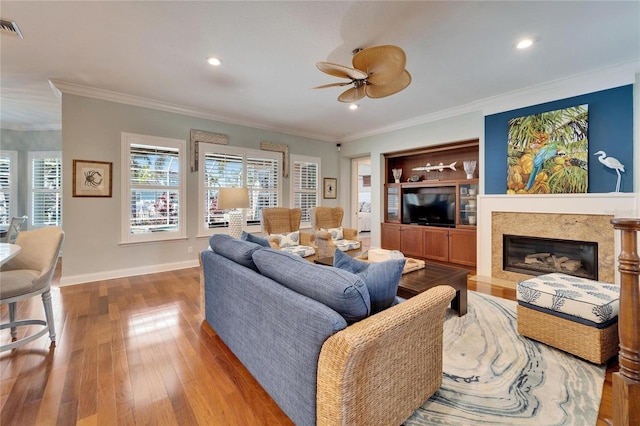 5616 Seagrass Pl, Apollo Beach, FL 33572 - living room featuring hardwood / wood-style flooring, baseboards, a fireplace, and ornamental molding