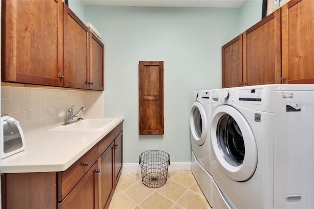 5616 Seagrass Pl, Apollo Beach, FL 33572 - laundry room with cabinet space, light tile patterned flooring, a sink, washer and dryer, and baseboards