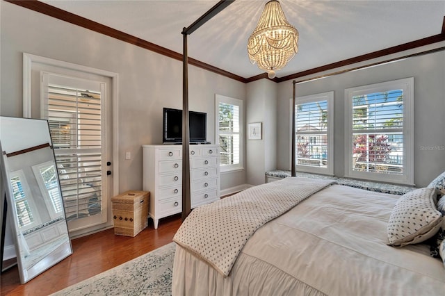 5616 Seagrass Pl, Apollo Beach, FL 33572 - bedroom with a chandelier, crown molding, and wood finished floors