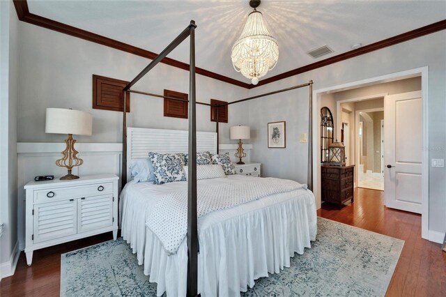 5616 Seagrass Pl, Apollo Beach, FL 33572 - bedroom with ornamental molding, wood finished floors, visible vents, and a notable chandelier