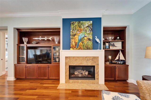 5616 Seagrass Pl, Apollo Beach, FL 33572 - living room with baseboards, a premium fireplace, ornamental molding, wood finished floors, and built in shelves